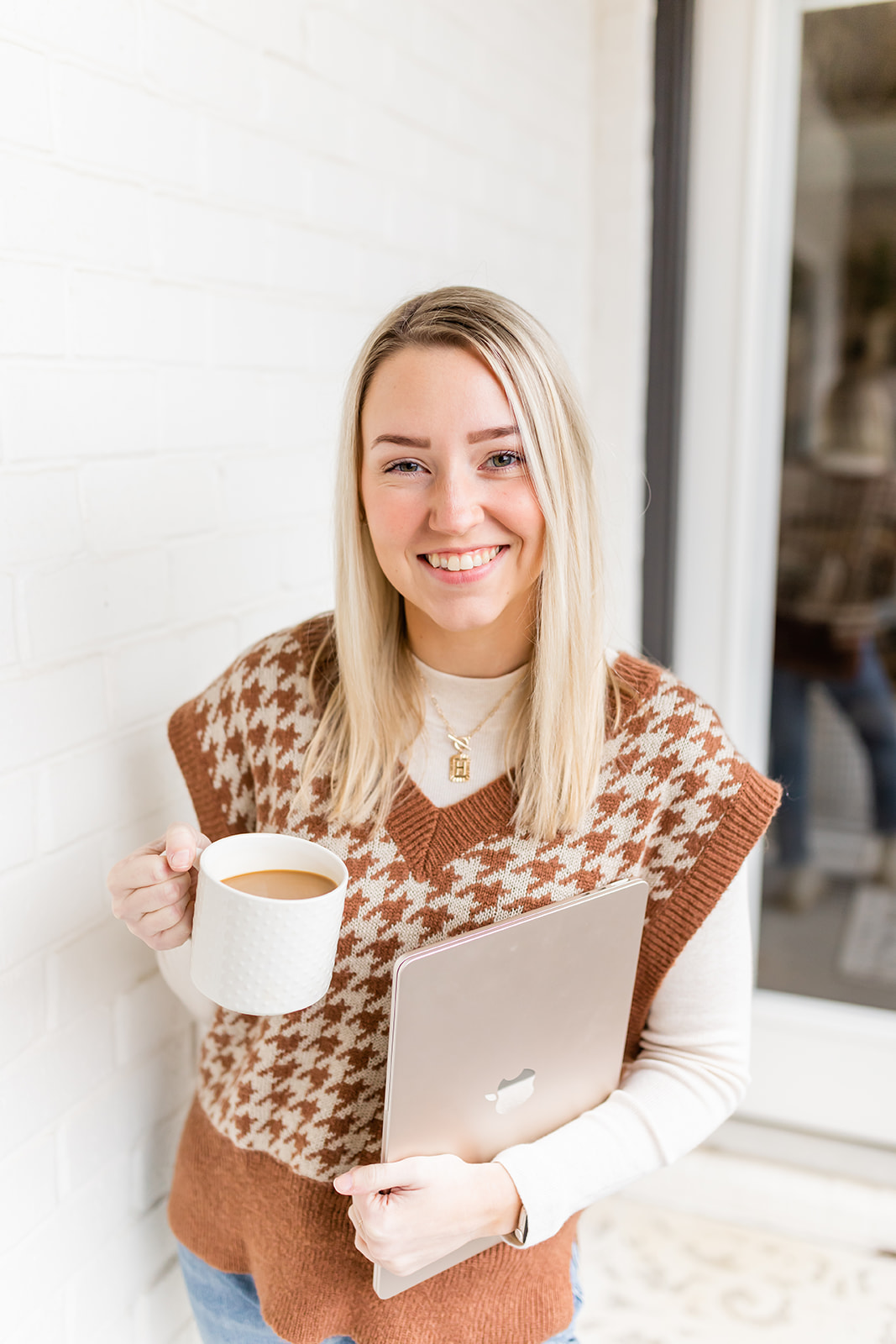 social media expert holding coffee and laptop