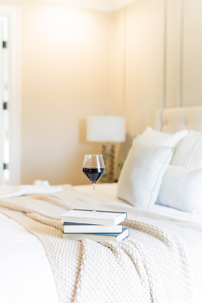 glass of red wine on a stack of books