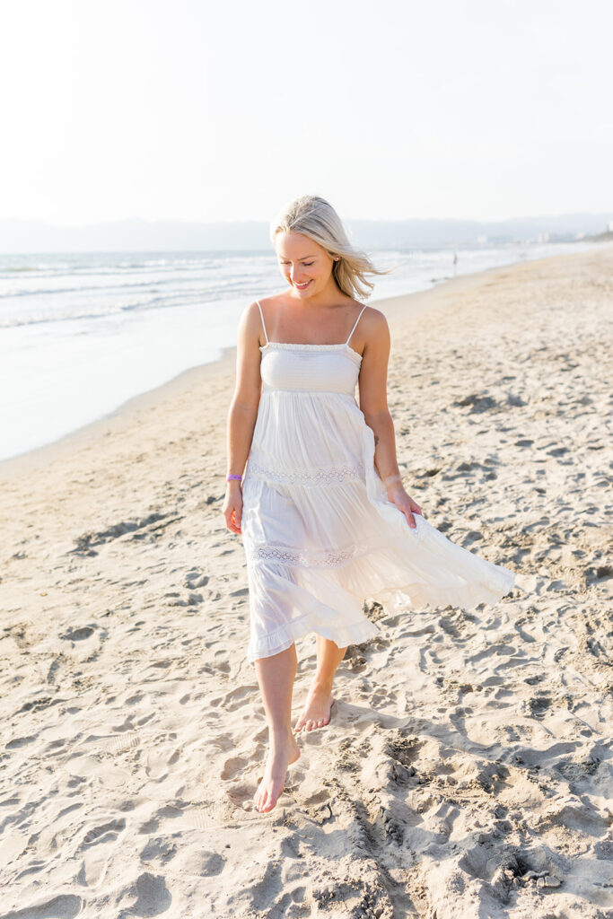 woman wearing simple white dress on beach