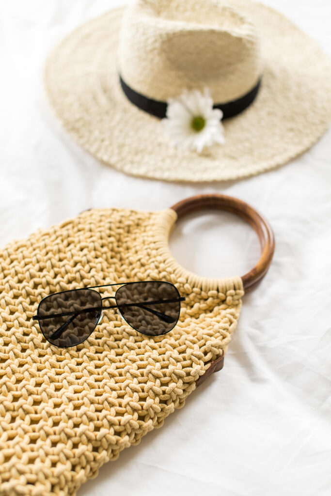 summer skincare essentials wide brimmed hat and sunglasses