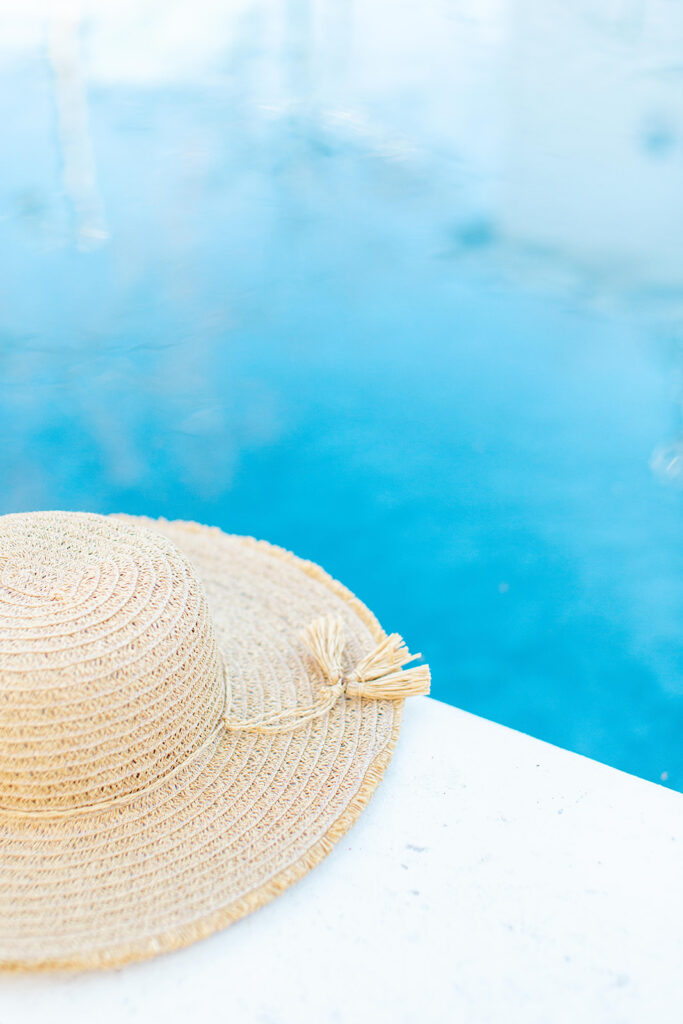 wide brimmed hat next to pool