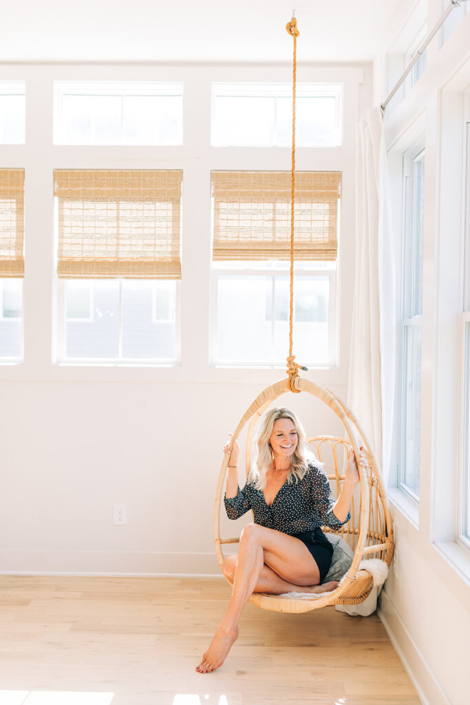 woman sitting on an indoor swing