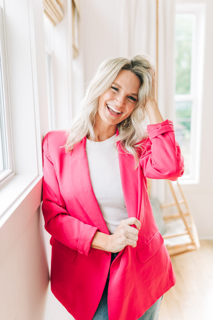 happy successful woman in pink blazer