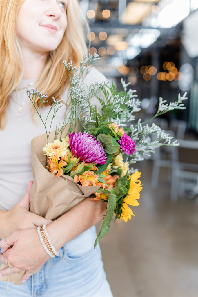 woman holding bouquet of flowers