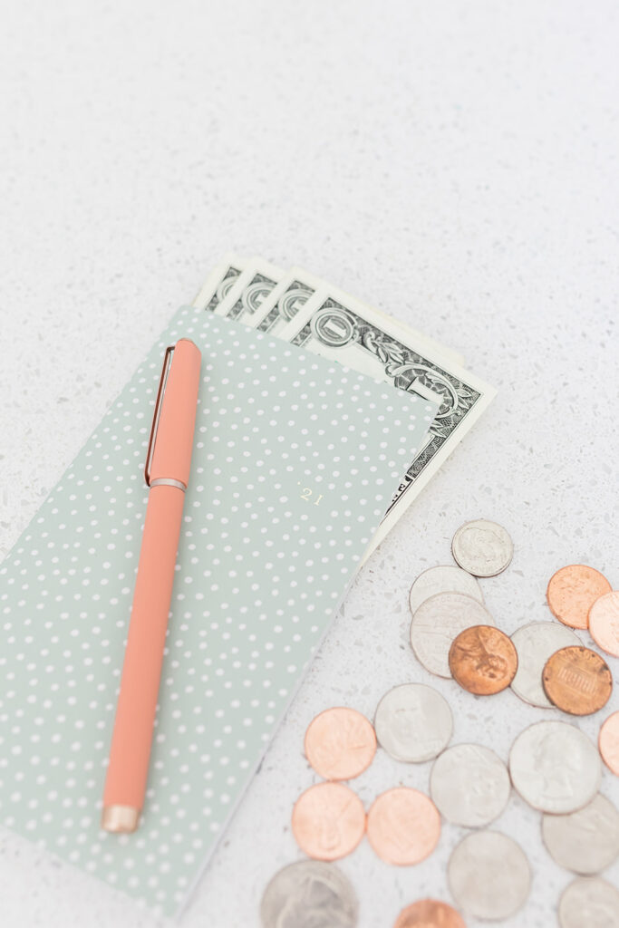 notebook and pen with money inside
