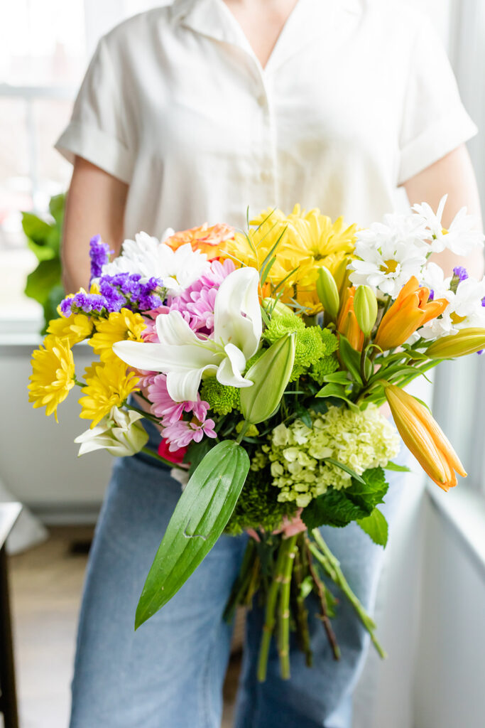 woman holding bouquet of flowers