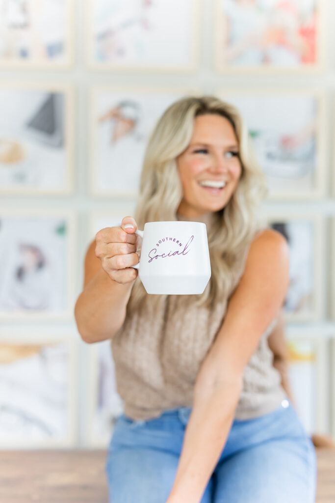 smiling woman holding southern social mug