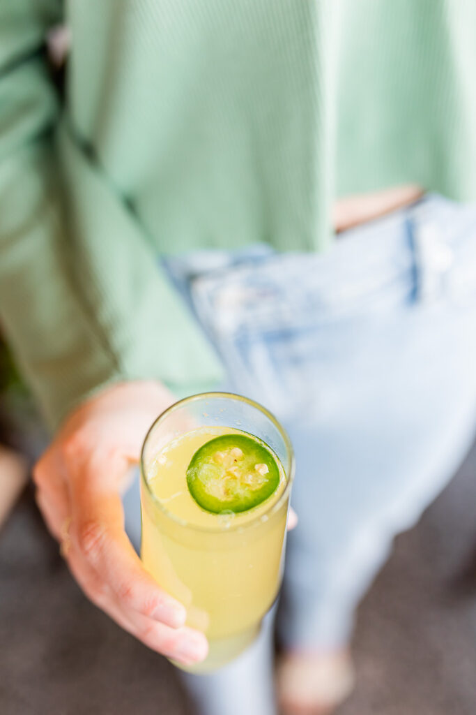 hand holding a jalapeño cocktail