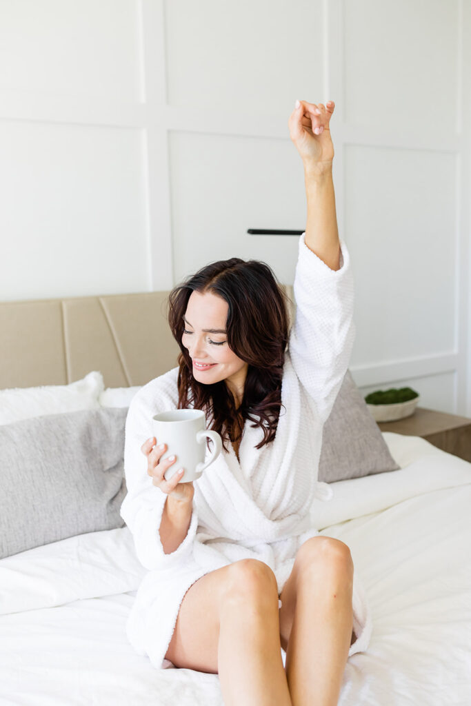 happy woman in robe holding coffee