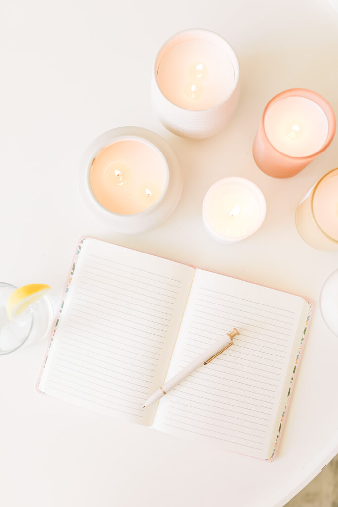 open notebook with pen and candles